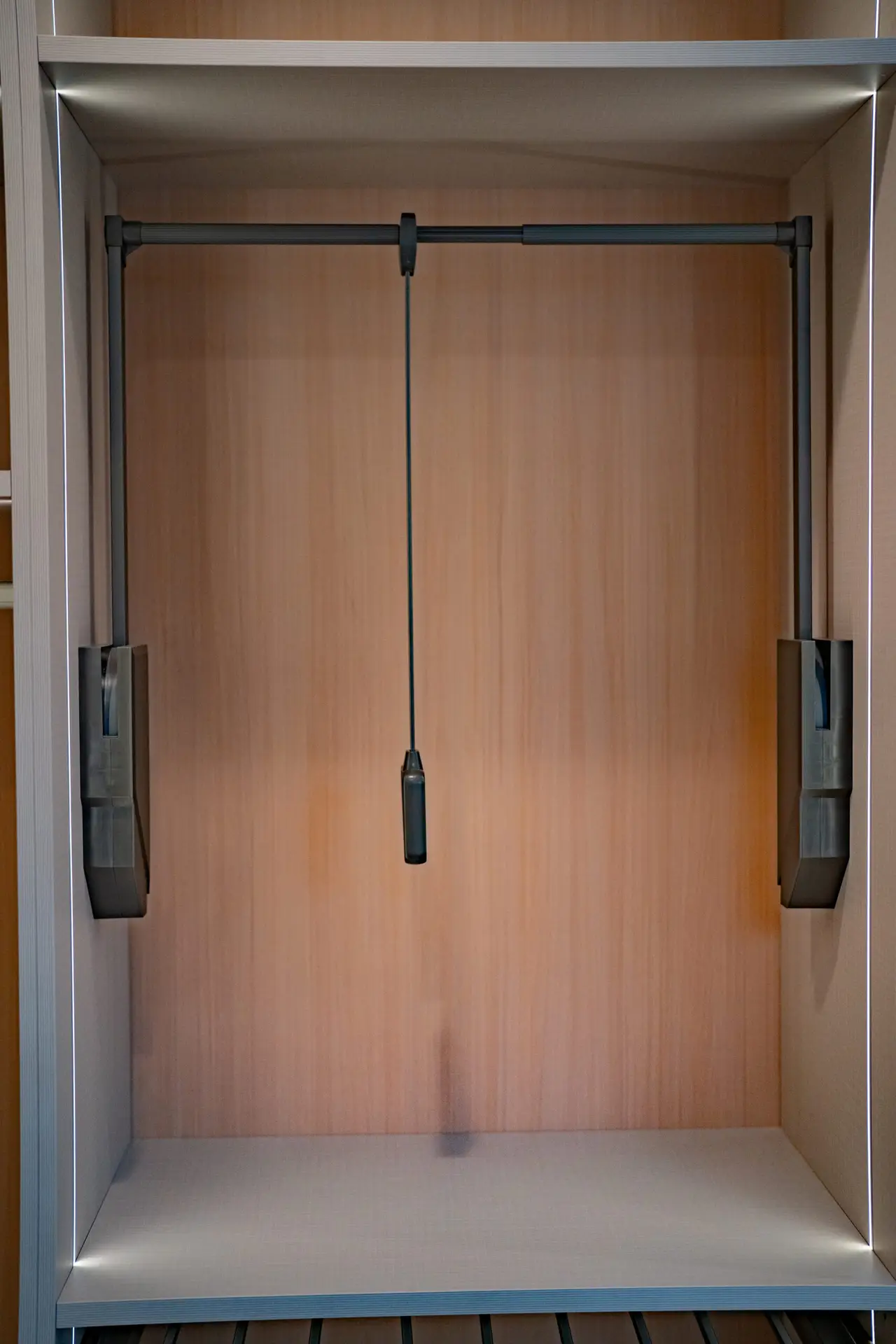 LED-lit custom closet shelving and hanging sections with built-in premium cabinetry