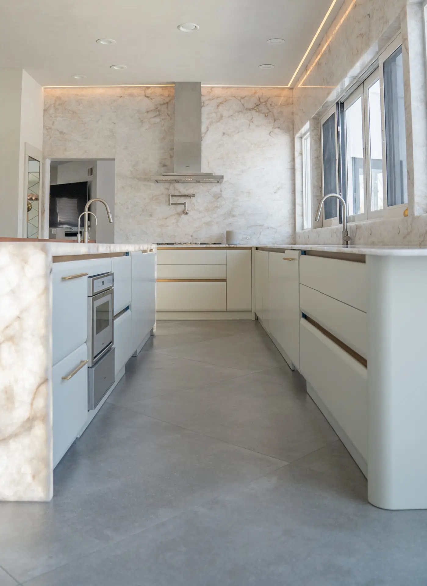 Custom kitchen island sink area with integrated functionality and luxury finishes