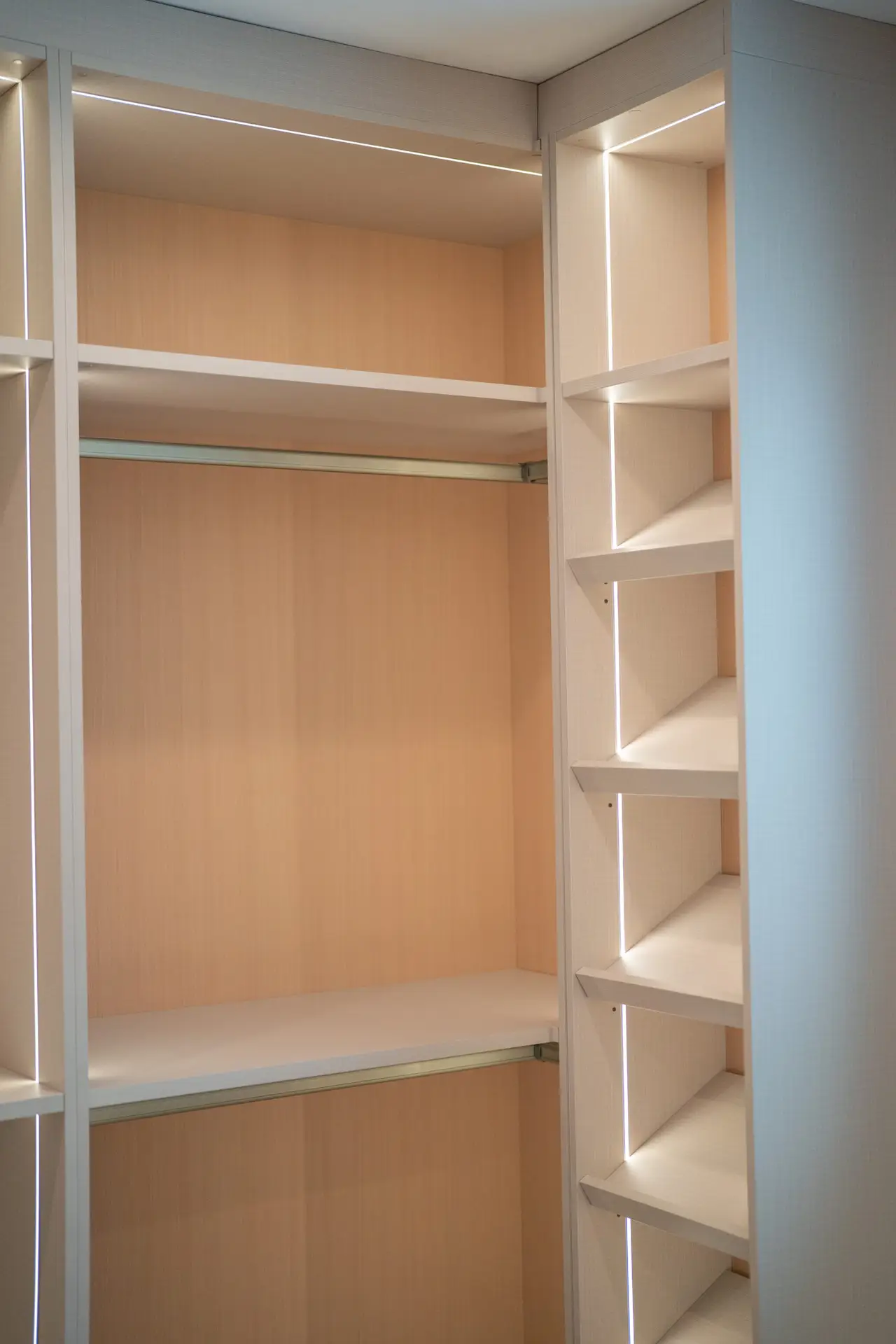 Built-in bench seating with drawer storage inside a custom luxury walk-in closet