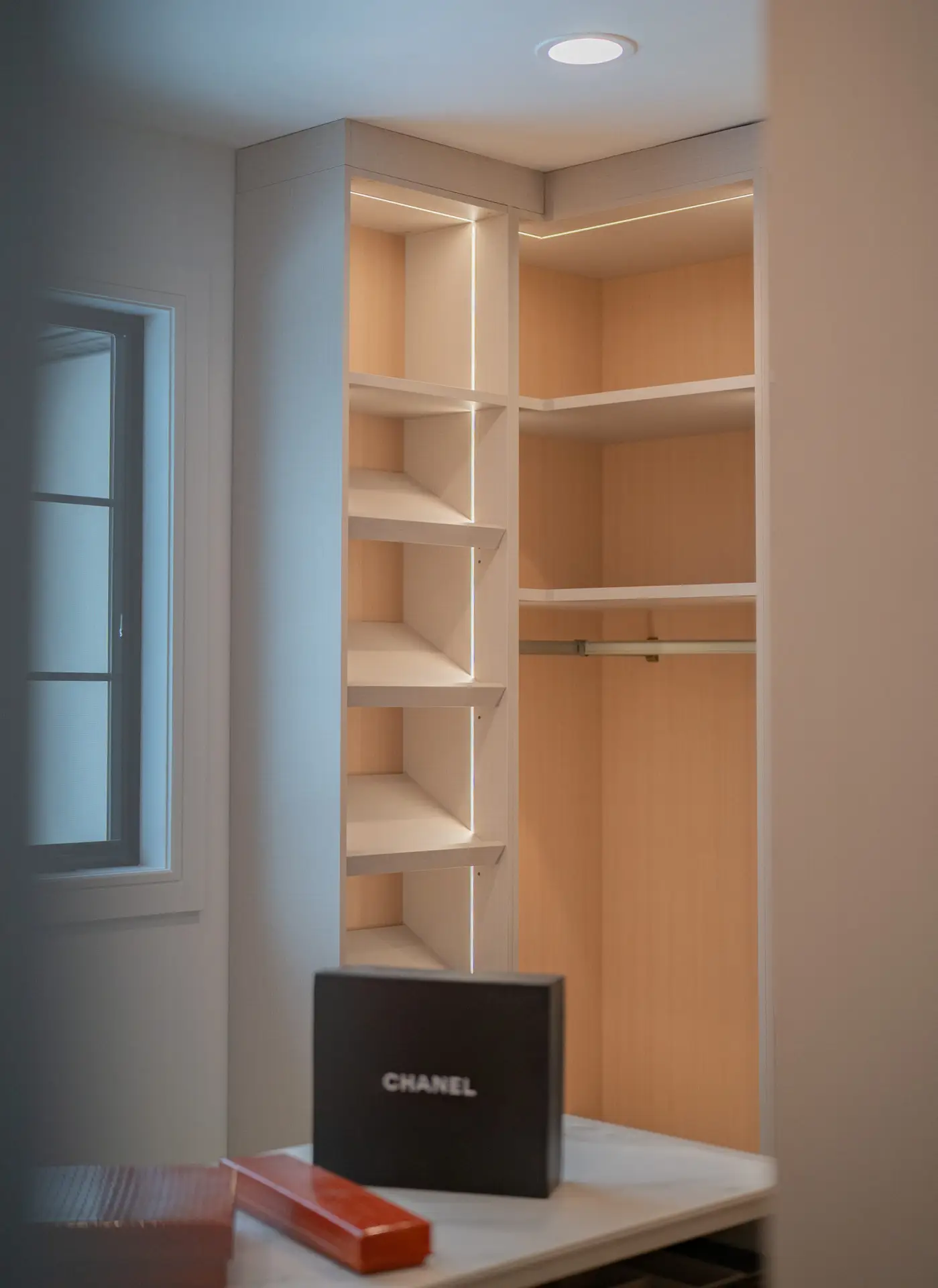 Premium American-made custom closet cabinet system with shelving, drawers, hanging sections, and elegant built-in details